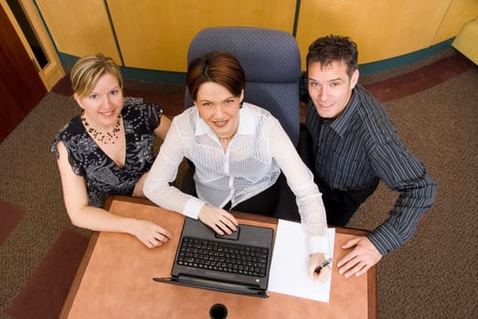 three business colleagues in a boardroom in a meeting
