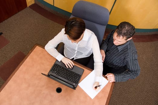 two business colleagues in a boardroom in a meeting