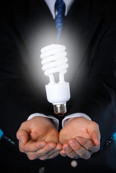 two hands with a floating light bulb