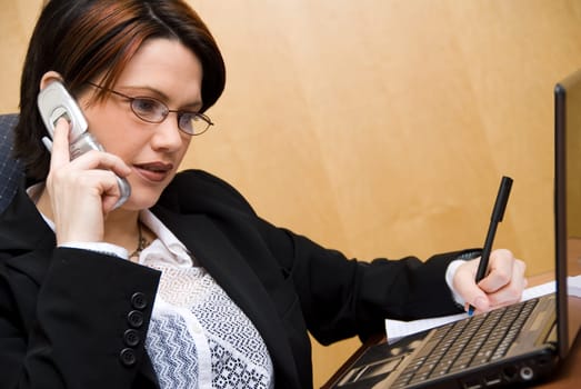 busy woman on the phone and on her laptop