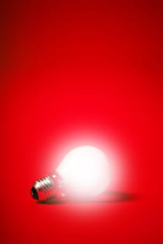 incandescent light bulb on a red background