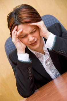 burnout woman at her work holding her head