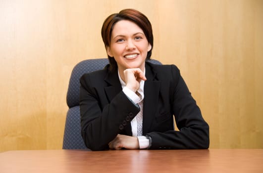 happy business woman in a boardroom table