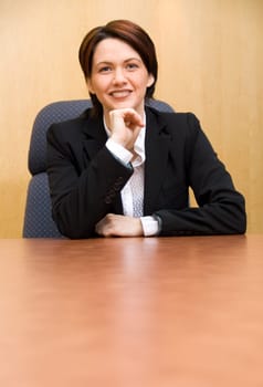 happy business woman in a boardroom table