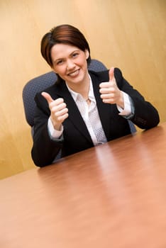 happy business woman in a boardroom table