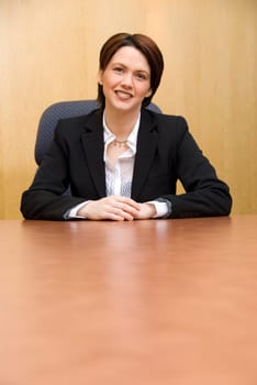 happy business woman in a boardroom table