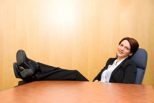 business woman with her feet up on the table