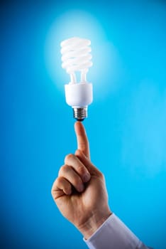 a hand with a floating light bulb on finger