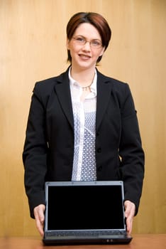 business woman holding her laptop to show people
