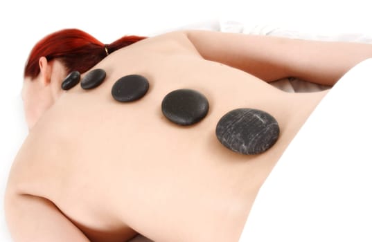woman getting a hot stone massage treatment