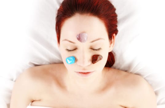 woman getting cold stone therapy on chakras