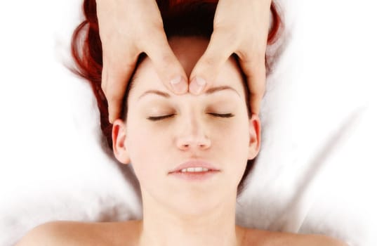 woman getting a head massage by therapist