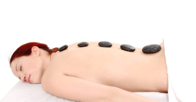 woman with red hair getting a stone massage