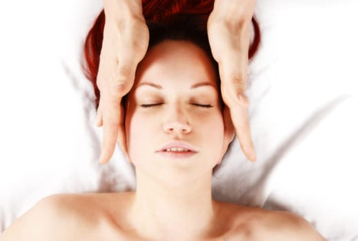 woman getting a head massage by therapist