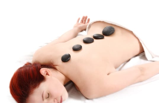 woman getting a hot stone massage on white background
