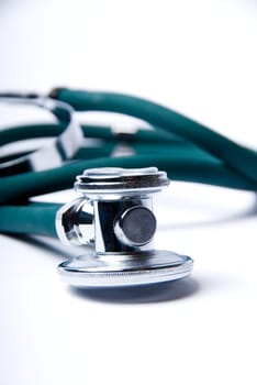 Stethoscope in green on an isolated white background