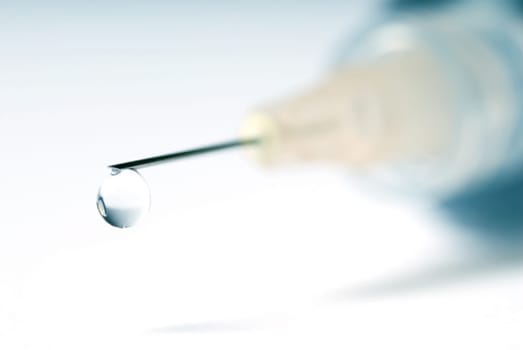 syringe in blue on an isolated white background