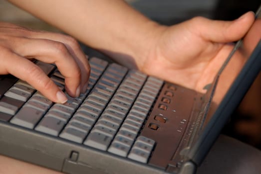 woman typing on laptop