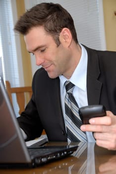 man with PDA and laptop