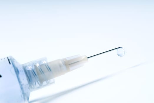 syringe in blue on an isolated white background