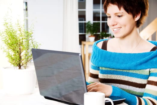 girl happy working with her laptop on the table