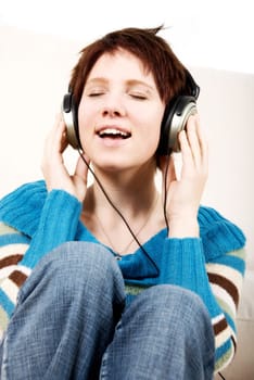girl in casual dress listening to mp3 music