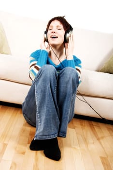 cute girl with headphone happy lying on the couch