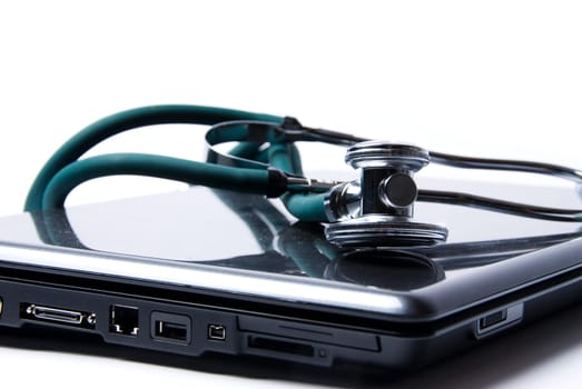 Stethoscope and laptop isolated on white backgound