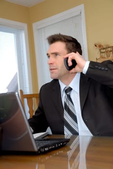 man in a suit and tie talking on the phone