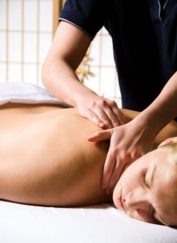 woman getting a good massage at a day spa