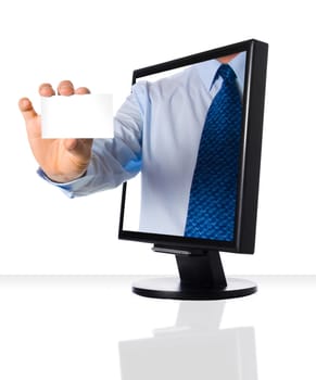 A hand giving a business card through a monitor