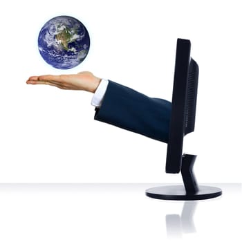 A hand from a monitor holding a planet