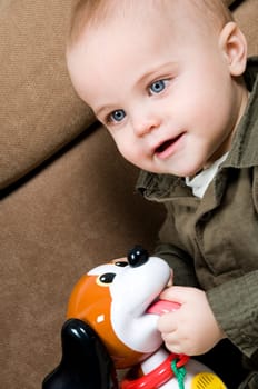 young baby boy son playing on the couch