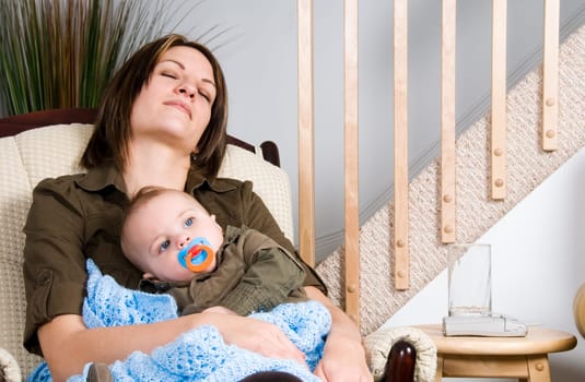 mother and her baby boy resting in a chair