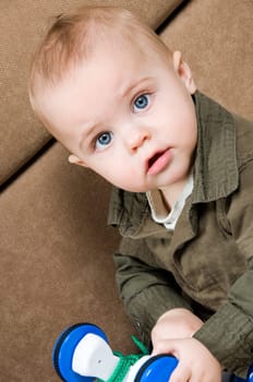 young baby boy son playing on the couch
