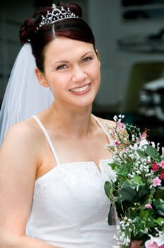White Bride at her wedding posing with veil