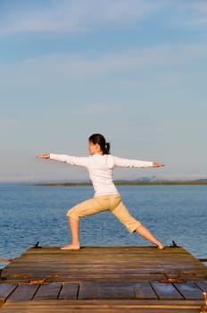 Yoga Woman on a dock by the ocean