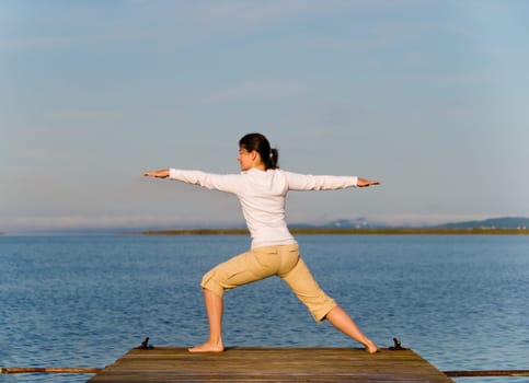 Yoga Woman on a dock by the ocean