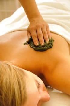 Beautiful woman in a spa with massage therapy