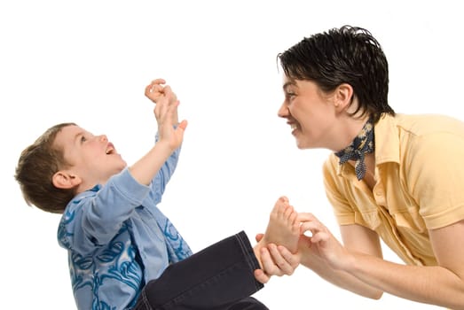 son being tickled by mom on white background