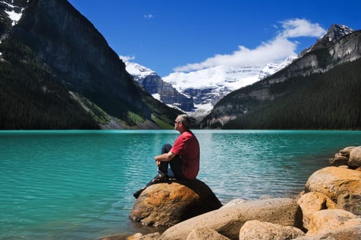 Man in red shirt on the lake shore