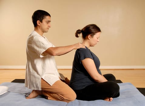Thai massage of the neck on matt