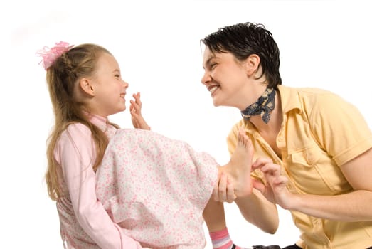 mom and daughter playing tickling on white background