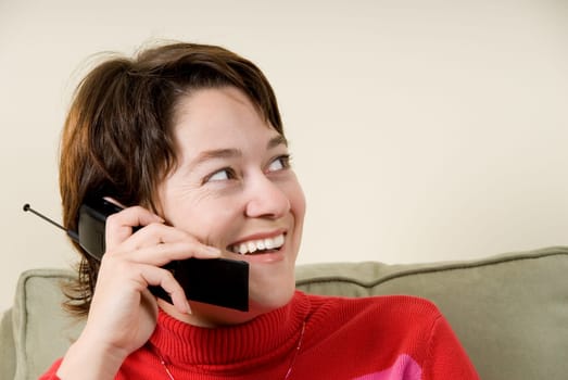 cute woman talking on the phone on couch