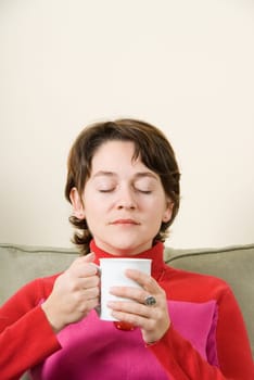 cute woman drinking coffee in a white cup