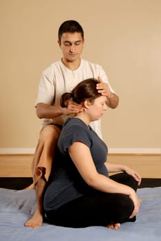 man massging woman client in the neck