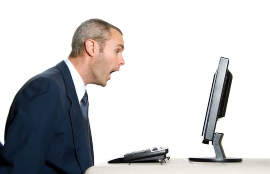 surprised man in blue suit in front of computer