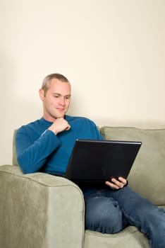 businessman in casual wear with laptop on couch