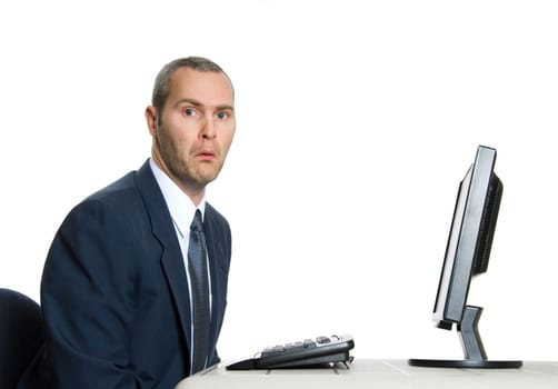 unhappy man in blue suit at office computer