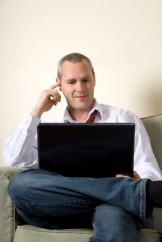 businessman looking at emails on his laptop